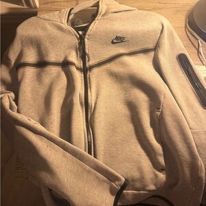 grey Nike tech 
tiny stain
